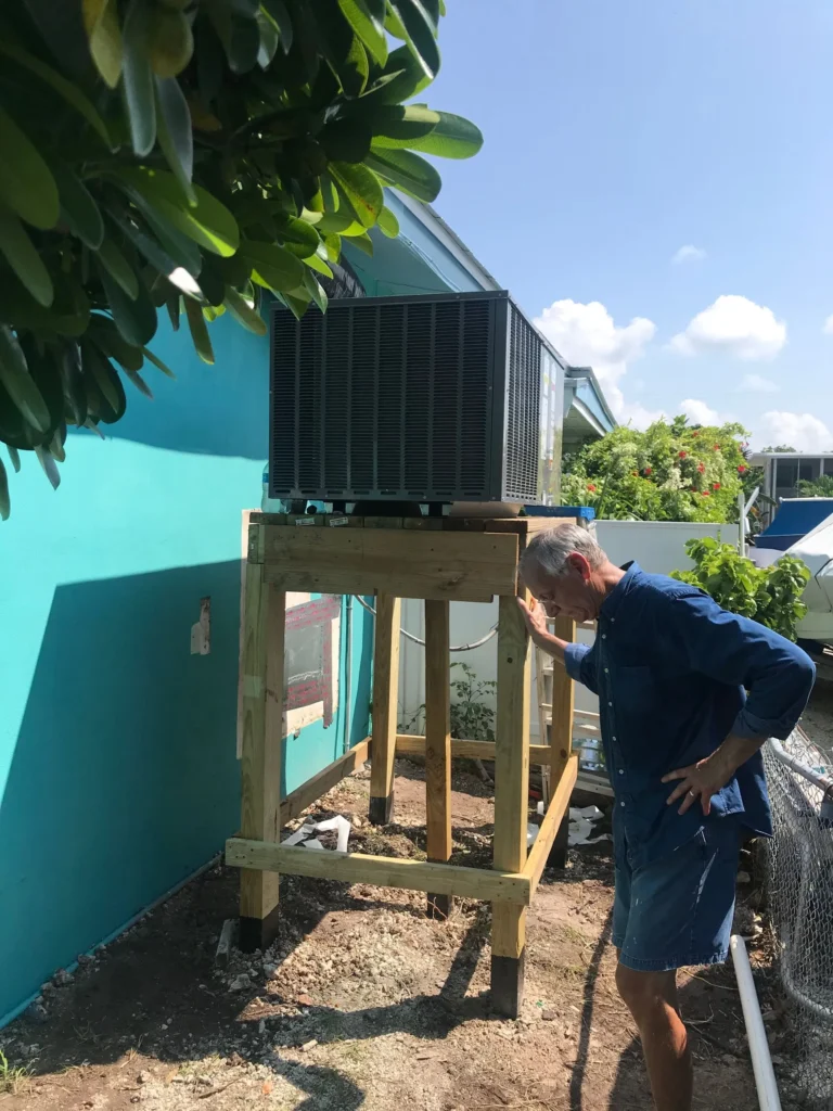 Owner Dave Link inspecting a packaged unit on a new elevated wood stand