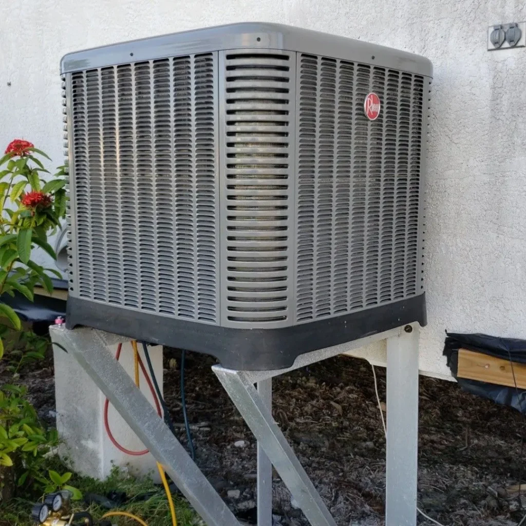 New Rheem condenser installed on a galvanized elevated stand beside a Brevard County home